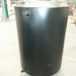 Stainless portable tank with carbon steel jacket